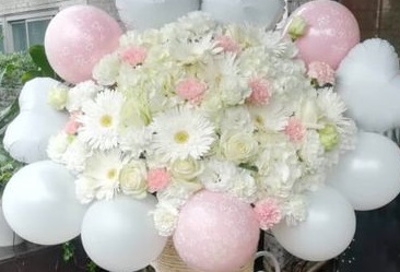 Small pink and white organic balloons surrounding 30 pink and white flowers