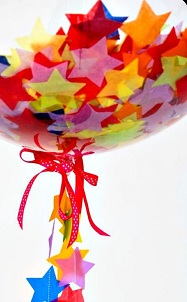 Single Bubble balloon with colored confetti and stars inside and on the stick on the sick with Red ribbons