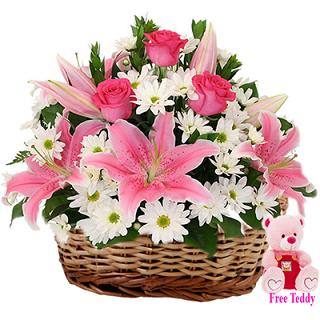 White Carnation and pink Liliums in basket with 6 inches teddy