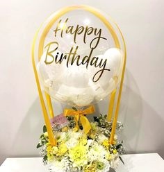 1 Clear transparent bubble bobo balloon with letter happy birthday Sticker stuffed with white balloons and tied with ribbon to yellow and white flower basket